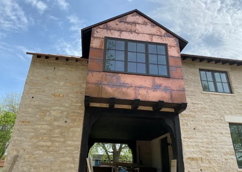 Copper metal panel facade on a stone building for Skylight Installation in Worthington